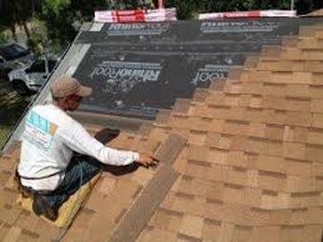 A roofing professional installs new shingles for roofing replacement on a home in Lehigh Valley.